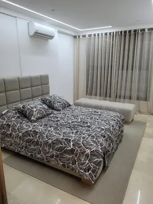 a bedroom with a large bed and a window at Jennaya - Appartement moderne, élégant et raffiné in Marrakech