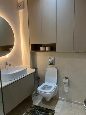 a bathroom with a white toilet and a sink at Jennaya - Appartement moderne, élégant et raffiné in Marrakech