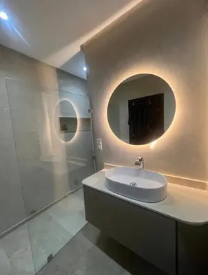 a bathroom with a sink and a mirror at Jennaya - Appartement moderne, élégant et raffiné in Marrakech