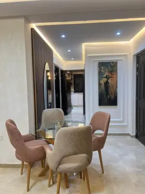 a dining room with a glass table and chairs at Jennaya - Appartement moderne, élégant et raffiné in Marrakech