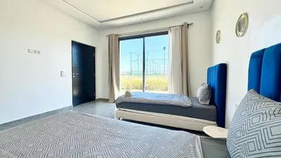 a bedroom with two beds and a window at New Villa Dali & Spa Paddel Marrakech in Marrakech