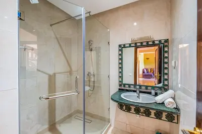 a bathroom with a sink and a shower at Cocon Ocre Pool and Balcony in Marrakech