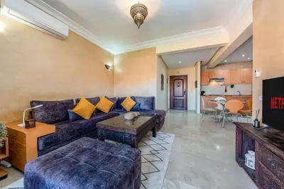 a living room with a couch and a table at Cocon Ocre Pool and Balcony in Marrakech