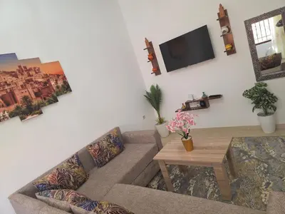 a living room with a couch and a tv at appartement lady Plaza 2 in Marrakech