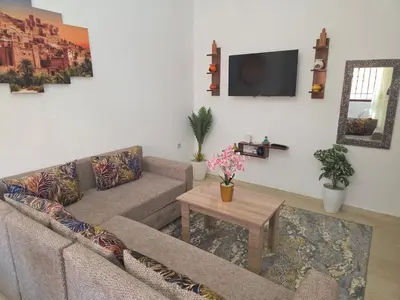a living room with a couch and a table at appartement lady Plaza 2 in Marrakech