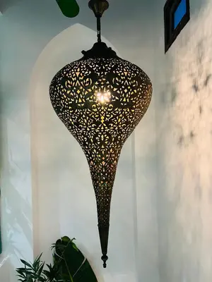 aendant light hanging from a white wall at Riad Dar L artiste in Marrakech