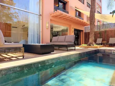 a swimming pool in front of a house at JARDIN VITTORIO - Marrakech - Hivernage - Heated & Luxury Pool in Marrakech