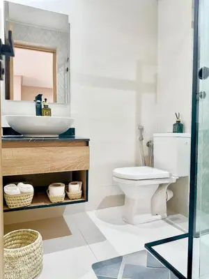 a bathroom with a sink and a toilet and a mirror at Majorelle Luxury Studio in Marrakech
