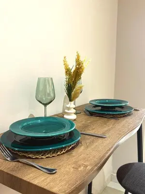 a table with blue plates and a glass at Majorelle Luxury Studio in Marrakech