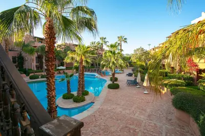 a resort with a swimming pool and palm trees at Your Unique Stay - Marrakech Place To Be in Marrakech