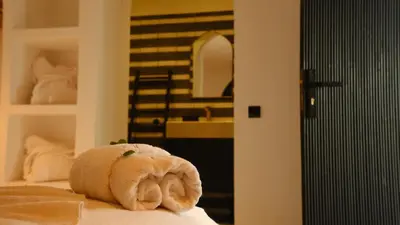 a stuffed animal is sitting on top of a bed at Riad Dar Siyah in Marrakech