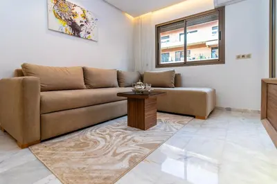 a living room with a couch and a table at Elegant Guéliz Apartment in Marrakech