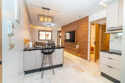 a kitchen with white cabinets and a counter at Elegant Guéliz Apartment in Marrakech