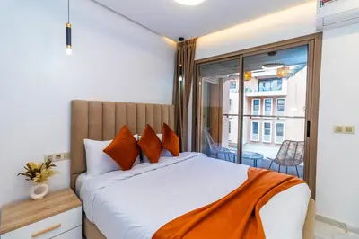 a bedroom with a large bed and a balcony at Elegant Guéliz Apartment in Marrakech