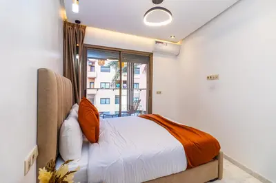 a bedroom with a bed and a window at Elegant Guéliz Apartment in Marrakech