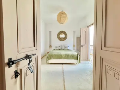 a bedroom with a bed in a room with a door at Maison Remedy et Spa Private Pool & Breakfast in Marrakech