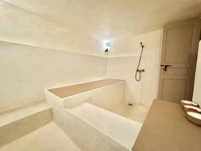 a white bathroom with a tub and a door at Maison Remedy et Spa Private Pool & Breakfast in Marrakech