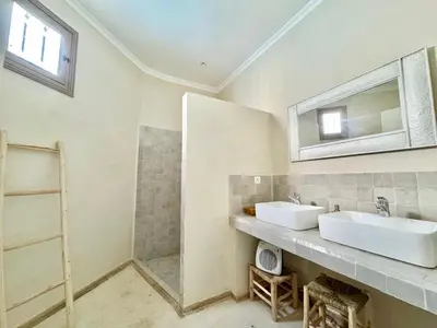 a bathroom with two sinks and a shower at Maison Remedy et Spa Private Pool & Breakfast in Marrakech