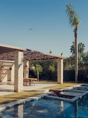 a swimming pool with a pavilion and a picnic table at LA VILLA 58 - Ecolodge - Marrakech in Marrakech