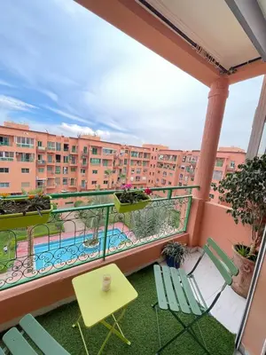 a balcony with chairs and a swimming pool at Dar Aicha in Marrakech