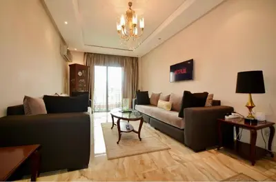 a living room with a couch and a table at Dar Aicha in Marrakech