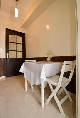 a dining room with a table and two chairs at Dar Aicha in Marrakech