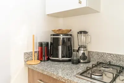 a kitchen counter with a coffee maker and a blender at Luxury 3BD Golf View Pool Fast Fiber WiFi in Marrakech