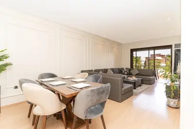 a living room with a table and a couch at Luxury 3BD Golf View Pool Fast Fiber WiFi in Marrakech