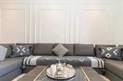 a living room with a couch and a table at Luxury 3BD Golf View Pool Fast Fiber WiFi in Marrakech