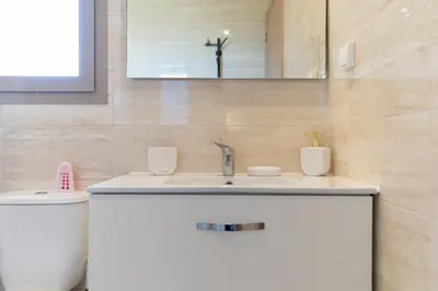 a bathroom with a sink and a toilet at Luxury 3BD Golf View Pool Fast Fiber WiFi in Marrakech