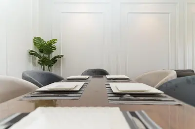a dining room table with chairs and a tableablish at Luxury 3BD Golf View Pool Fast Fiber WiFi in Marrakech