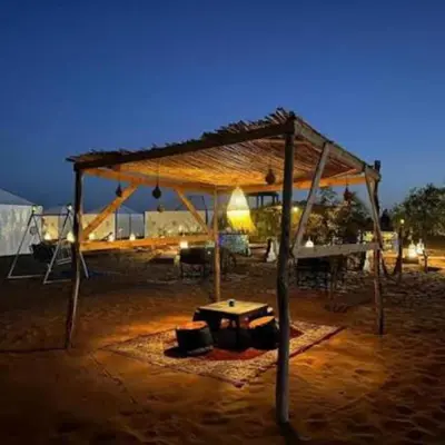a pavilion with a table in the middle of a field at Yassen luxury camp in Marrakech