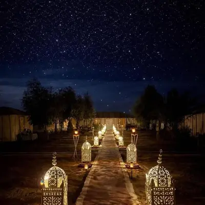a row of lights in a field at night at Yassen luxury camp in Marrakech