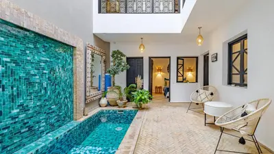 a swimming pool in the middle of a living room with a tile floor at Riad Awajana Marrakech - Piscine - Jacuzzi in Marrakech