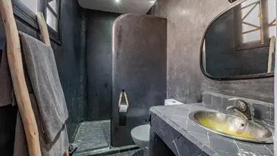 a bathroom with a sink and a toilet at Riad Awajana Marrakech - Piscine - Jacuzzi in Marrakech