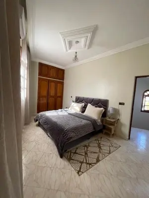 a bedroom with a large bed in a room at Villa Familiale in Marrakech