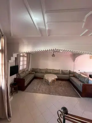 a living room with a couch and a table at Villa Familiale in Marrakech