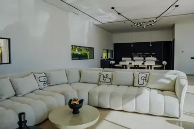 a living room with a white couch and a table at MIKESTAY - Villa Sherazade in Marrakech