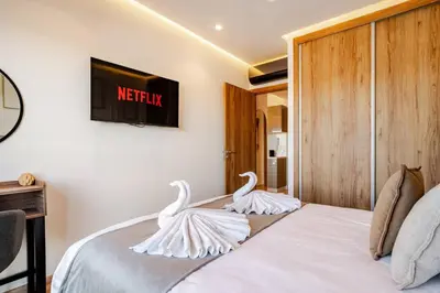 two white swans sitting on top of a bed at Marrakesh, Noria Residence, Luxury 1BR, Atlas View in Marrakech