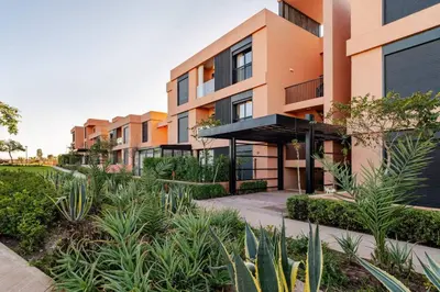 an image of an apartment complex with plants at Marrakesh, Noria Residence, Luxury 1BR, Atlas View in Marrakech