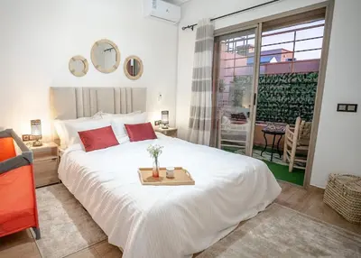 a bedroom with a large white bed with a tray on it at le 26M in Marrakech
