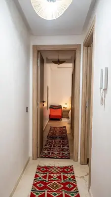 a hallway with a room with a rug on the floor at le 26M in Marrakech