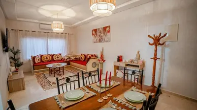 a living room with a table and a couch at le 26M in Marrakech