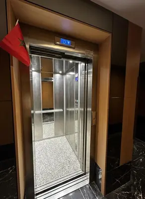 an elevator in a building with a sign on it at Apartment in heart of Marrakech near Guéliz & Medina in Marrakech