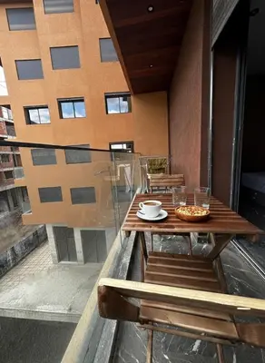 a table and chairs on a balcony with a building at Apartment in heart of Marrakech near Guéliz & Medina in Marrakech