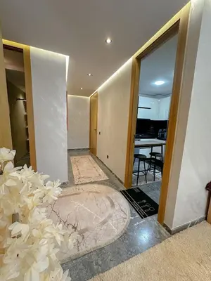 a hallway with a room with a dining room and a table at Apartment in heart of Marrakech near Guéliz & Medina in Marrakech