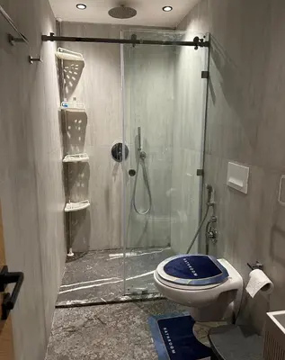 a bathroom with a glass shower with a toilet at Apartment in heart of Marrakech near Guéliz & Medina in Marrakech