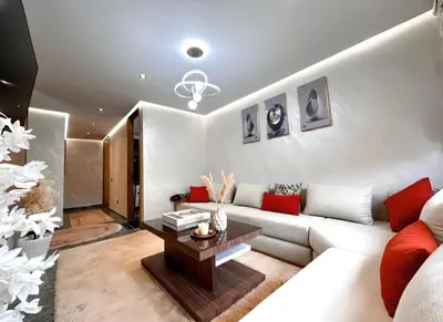 a living room with a white couch and red pillows at Apartment in heart of Marrakech near Guéliz & Medina in Marrakech