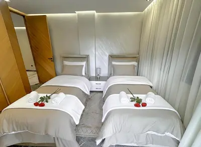 a room with three beds with towels and tomatoes on them at Apartment in heart of Marrakech near Guéliz & Medina in Marrakech