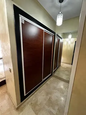 a room with a closet with wooden doors in it at Calm Apartment with Pool in Geuliz marrakech Close to Medina in Marrakech